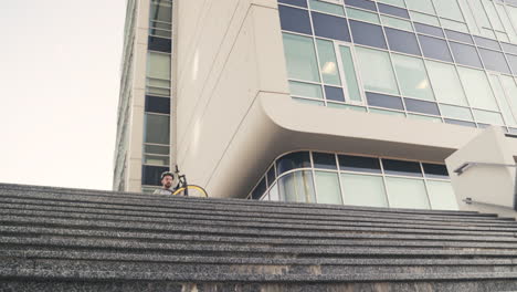 Food-Delivery-Man-Down-The-Stairs-Carrying-His-Bike