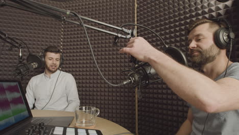 Two-Bearded-Men-Having-A-Funny-Conversation-In-A-Radio-Recording-Studio-1