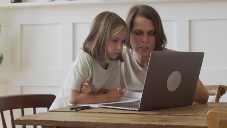 Ein-Blondes-Mädchen-Und-Ihre-Mutter-Lesen-Konzentriert-Den-Bildschirm-Eines-Laptops