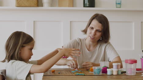 A-Little-Blonde-Girl-And-Her-Mother-Playing-With-Modeling-Clay