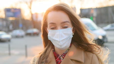 Camera-Zooming-Out-On-Sad-Girl-Face-In-Medical-Mask-Standing-At-Street-In-City-And-Looking-At-Camera