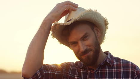 Close-Up-Of-The-Handsome-Man-With-Beard-Turning-To-The-Camera-And-Smiling-In-The-Field-At-The-Dawn