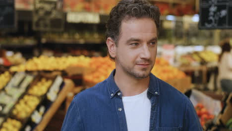 Portrait-Shot-Of-The-Young-Handsome-Man-Smiling-Happily-To-The-Camera-At-The-Grossery-Supermarket