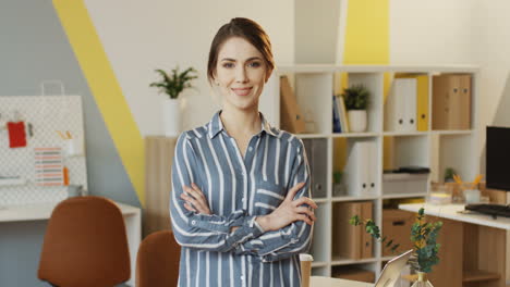 Portrait-Shot-Of-The-Young-Attractive-Woman-With-Hands-Crossed-In-Front-Standing-And-Posing-In-The-Urban-Office