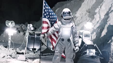 Spaceman-From-Nasa-In-The-Costume-And-Head-Helmet-Holds-A-Us-Flag-While-Looking-Direclty-Into-The-Camera