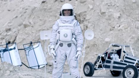 Woman-Astronaut-In-A-Space-Suit-Looks-Direclty-Into-The-Camera-And-Smiles