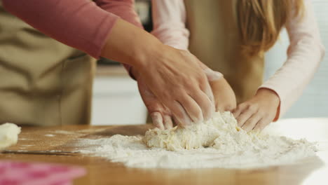 Close-Up-Of-The-Hands-Of-Mother-And-Teen-Daughter-Making-A-Dough-Together
