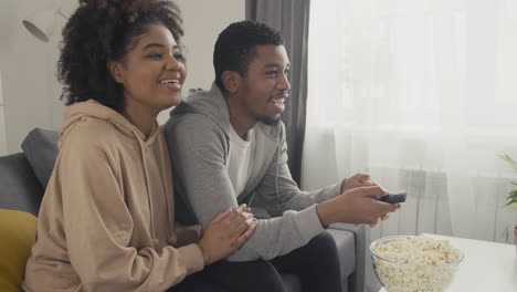 Young-Couple-Choosing-A-Movie-With-The-Remote-Control