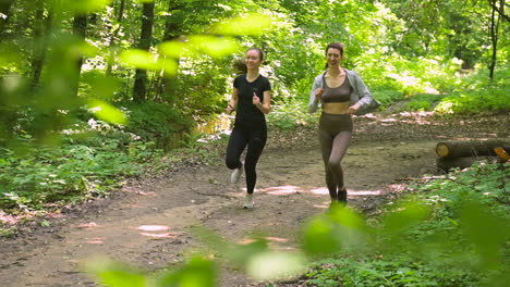 Two-Sportswomen-Running-In-The-Woods-1