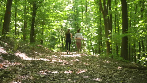 Back-View-Of-Two-Sportswomen-Running-In-The-Woods-2