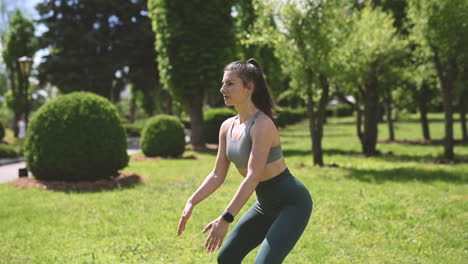 Beautiful-Brunette-Woman-Doing-Jump-Squats-In-The-Park-1