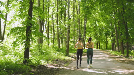 Back-View-Of-Two-Sportswomen-Running-In-The-Woods-4