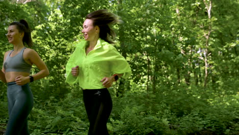 Two-Happy-And-Smiling-Sportswomen-Running-In-The-Park