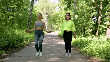 Fit-Women-Doing-Jumping-Jacks-In-The-Park