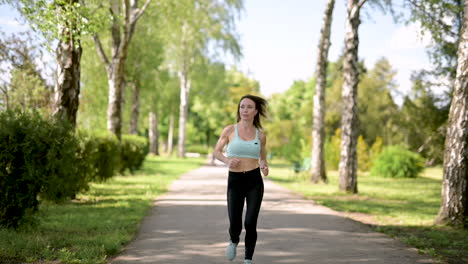 Smiling-Sportswoman-Running-At-The-Park-In-A-Sunny-Day
