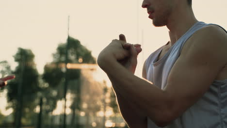 Close-Up-Of-A-Concentrated-Sportsman-Stretching-Wrists-And-Hands