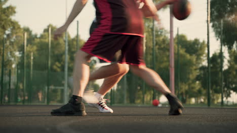 Two-Male-Basketball-Players-Dribbling-In-Outdoor-Basketball-Court