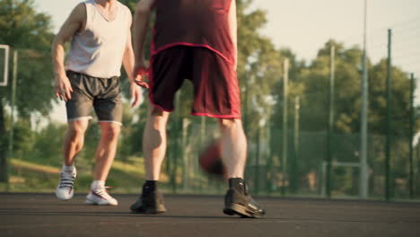 Two-Male-Basketball-Players-Dribbling-In-Outdoor-Basketball-Court-1