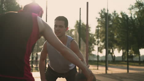 Close-Up-Of-A-Skillfull-Basketball-Player-Doing-A-Dribble-Crossover-Against-His-Opposing-Defender-In-An-Outdoor-Basketball-Court