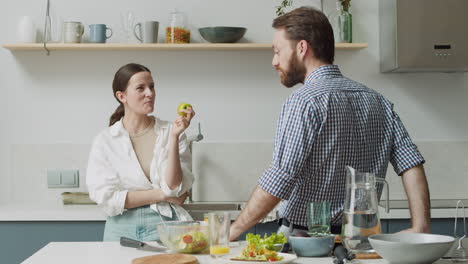 Couple-Standing-And-Chatting-In-A-Modern-Style-Kitchen