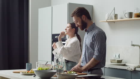 Laughing-Couple-Having-Fun-Together-In-A-Modern-Syle-Kitchen