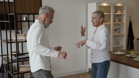 Happy-Senior-Couple-Having-Fun-And-Dancing-At-Home-1