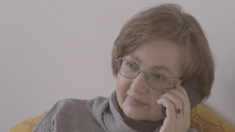 Senior-Woman-With-Eyeglasses-Talking-On-The-Phone