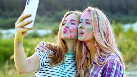 Portrait-Of-The-Cheerful-And-Pretty-Young-Blond-Girls-Smiling-To-The-Smartphone-Camera-While-Taking-Selfie-Photos