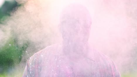 Portrait-Of-The-Young-Handsome-Joyful-Guy-Smiling-To-The-Camera-While-Standing-Outdoor-And-Smiling-In-Paint-Powder-In-Holi-Festival