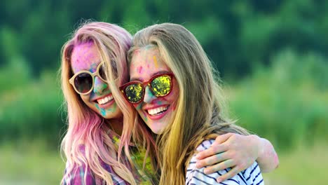 Portrait-Shot-Of-The-Cute-And-Beautiful-Blonde-Girls-In-Sunglasses-Smiling-And-Laughing-To-The-Camera-While-Posing-At-The-Holi-Fest-Celebration