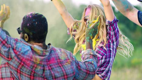 Rear-Of-The-Young-Guy-With-Blond-Girl-Dancing-In-Paints-Powder-At-The-Holi-Festival-In-The-Field
