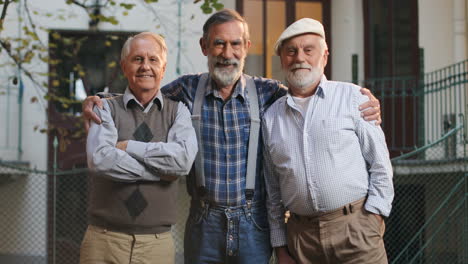 Portrait-Of-The-Three-Old-Cheerful-Men-Hugging-And-Smiling-While-Posing-To-The-Camera