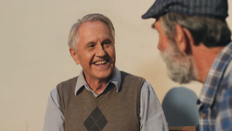 Close-Up-Of-The-Two-Cheerful-Retired-Men-Laughing-And-Chatting-Outdoors