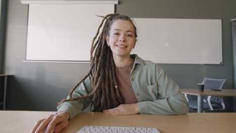 Young-Girl-With-Dreadlocks-Making-A-Presentation-Sitting-At-A-Table-In-Class