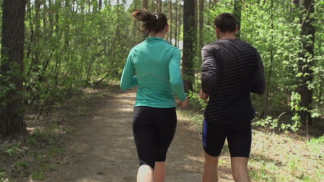 Sporty-Couple-Running-Through-The-Forest