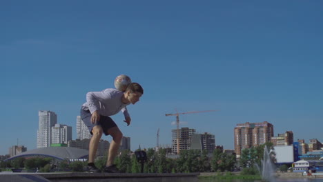 Young-Athlete-Man-Playing-With-Soccer-Ball-In-The-City