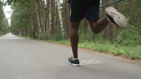Camera-Focuses-On-Feet-Of-Man-Running-In-The-Forest