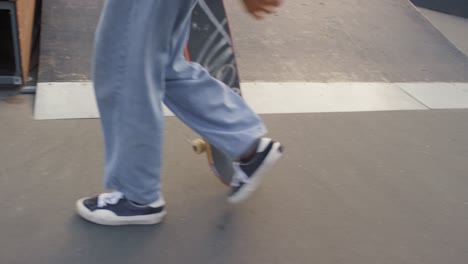Camera-Focuses-On-Young-Man-Legs,-Skate-Shoes-And-Skateboard