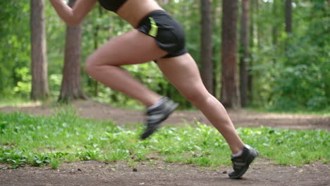 Side-View-Of-A-Crouching-Woman-Ready-To-Start-Running-In-The-Forest