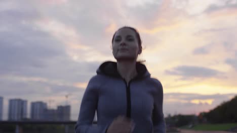 Sportive-Woman-In-Hoodie-Running-In-The-City-While-Training-Outdoors-In-Early-Morning-1