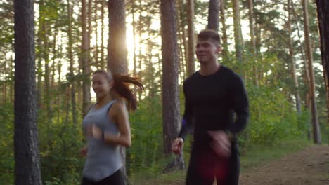 Happy-Couple-Running-Together-In-The-Forest
