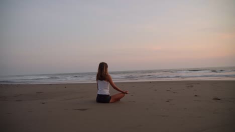 Pretty-Woman-Doing-Yoga-On-A-Sandy-Beach