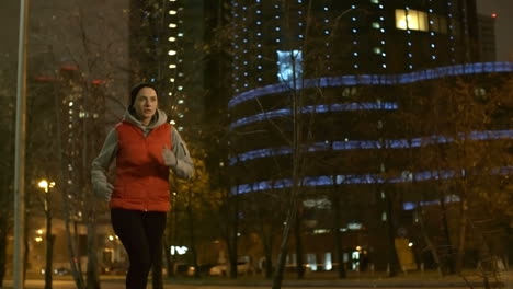Woman-In-Sportswear-Running-In-The-City-At-Night-In-Winter