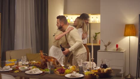 Wife-And-Husband-Welcome-Their-Son-And-Daughter-In-Law-Into-In-Living-Room-To-Celebrate-Thanksgiving