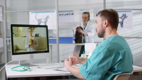 Male-Veterinarian-Giving-Online-Consultation-Via-Video-Call-And-Talking-To-A-Little-Girl-Holding-Her-Hamster