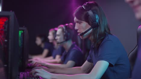 Modern-Team-Of-E-Sport-Gamers-Taking-Part-In-Online-Cybersport-Competition,-Successfully-Winning-It-And-Doing-High-Five