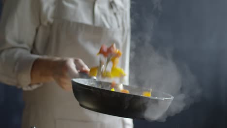 Close-Up-Of-Unrecognizable-Chef-Tossing-Chopped-Vegetables-From-A-Pan
