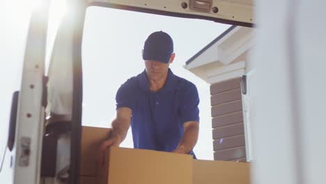 Delivery-Man-At-Van-Scanning-Boxes-With-Barcode-Scanner