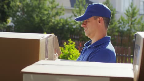 Männlicher-Postkurier,-Der-Pakete-Im-Postwagen-überprüft