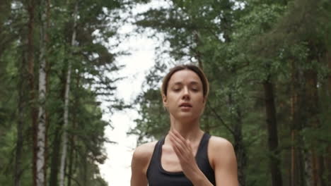 Determined-Young-Woman-Wearing-Sport-Top-Running-In-Forest-In-Morning
